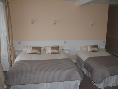 a double and single bed in one of the bedrooms